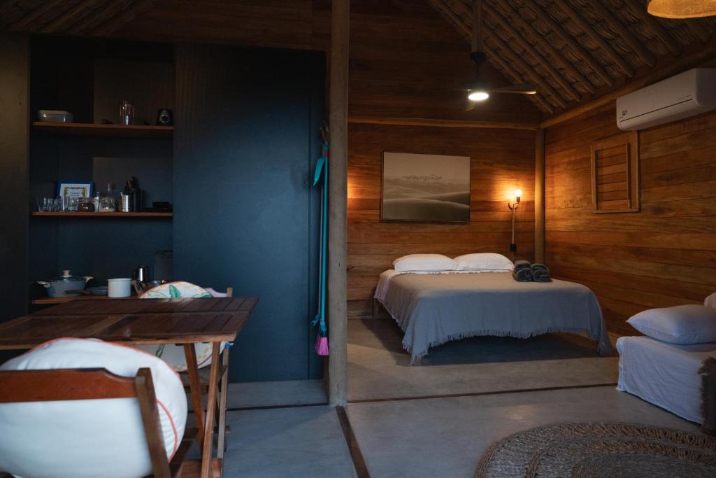 Sable bungalow interior with timber walls, a double bed and a kitchenette